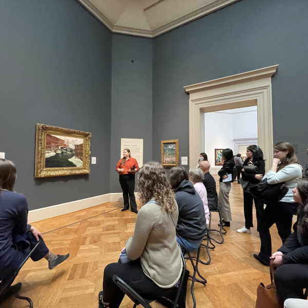 An image of Elizabeth Mangone standing in front of the audience for the pop-up talks